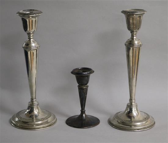 A pair of George V silver candlesticks, William Hutton & Sons, Birmingham, 1914/5 and one other smaller silver candlestick.